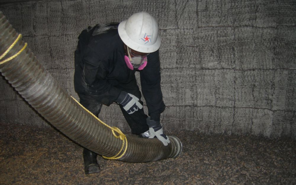 field tech vacuuming ceramic media