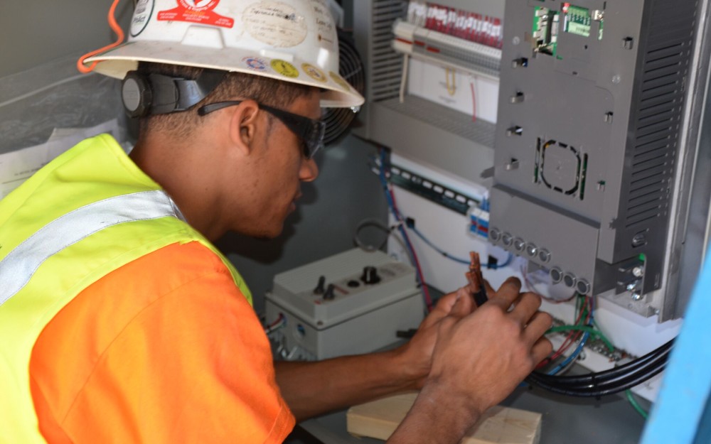 A technician troubleshooting a control panel