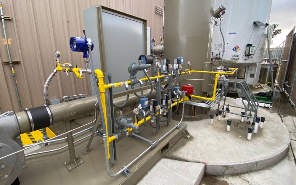 Enclosed flare and gas train