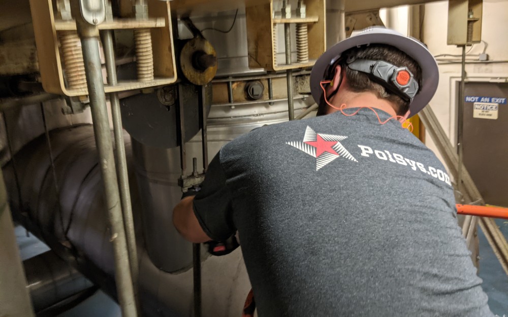 PolSys field technician working on equipment