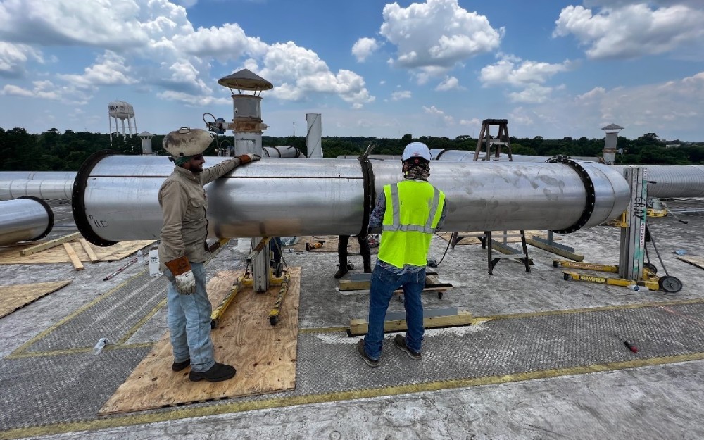 Technicians working on ductwork