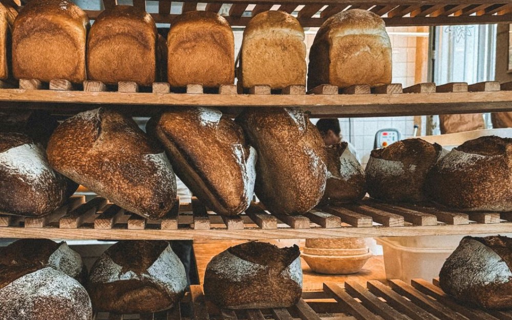 Bread stacked on shelves at an industrial bakery