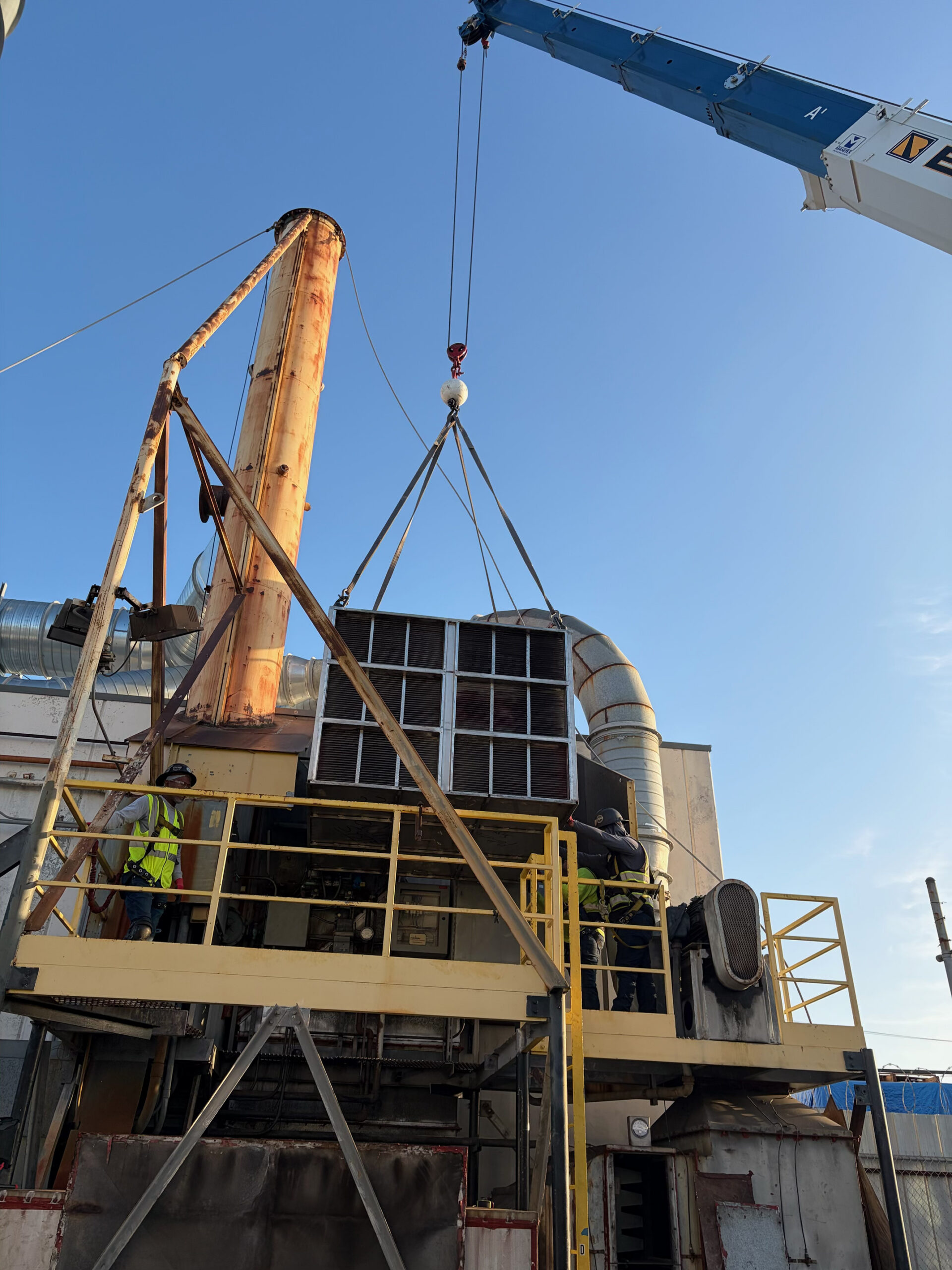 Crane installing new heat exchangers on site
